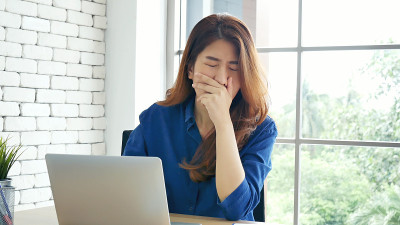 女子伸直手臂举起坐在不正确的位置的家庭办公室书桌。年轻亚洲女人的背部累了工作身体压力背痛办公室综合症