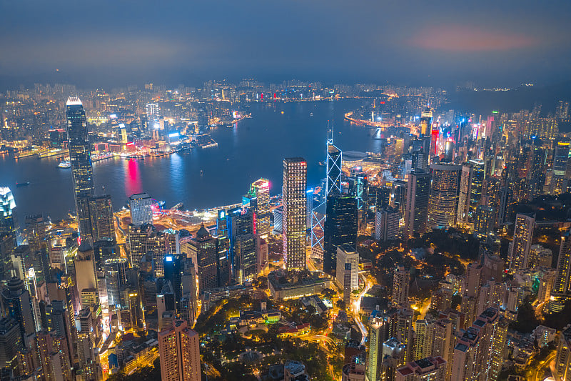 航拍香港维多利亚港两侧的千幢摩天大楼。山顶上的夜景。