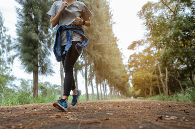 A young woman running at natural park.