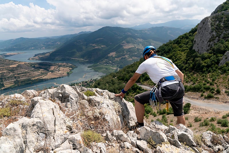 准备爬山。个人视角的登山装备包括钩环、背带、绳索和登山靴