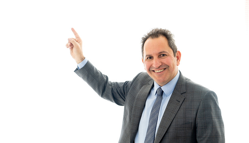 Studio portrait of Mature business man pointing as