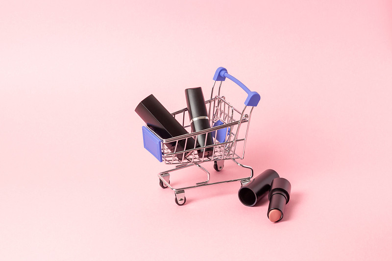 Lipsticks in black cases are located in a shopping