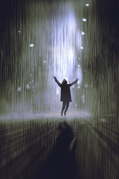 夜雨中举起手臂的人的剪影