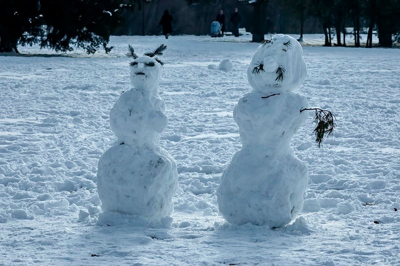 冬天的场景，在公园里用手边的材料堆雪人