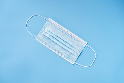 Isolated face mask on a blue background. Corona vi