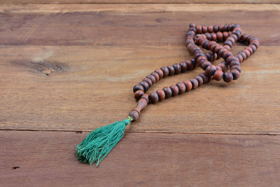 close up of wood tasbih with blur bokeh on wooden 