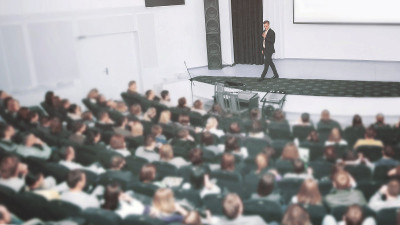 在商业会议上演讲并做演示。观众人数众多