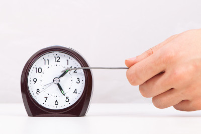Hand pulling clock hand forward