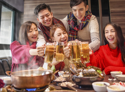 快乐的朋友们在火锅店喝酒、干杯