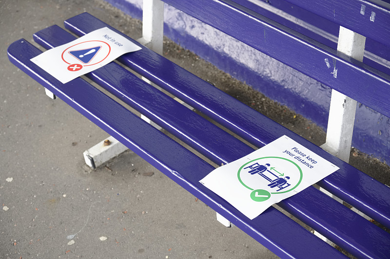 Social distancing sign on seat at train station