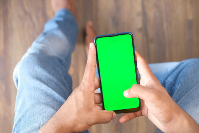 年轻人在室内使用智能手机的后视图