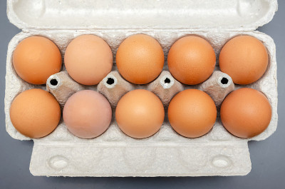 Brown chicken eggs in cardboard packaging close-up