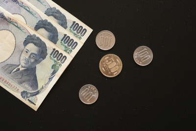 日本货币纸币和硬币上暗背景，银行经济金融概念，日本货币投资，利润和储蓄