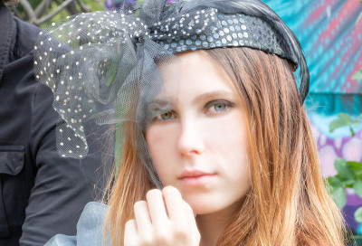 年轻女子与鲦鱼的眼睛和同龄人，在复古野餐非常优雅的服装波西米亚别致，美丽的时代，带着面纱比比帽，蒸汽