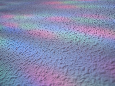 White stipple effect wall with rainbow lights text