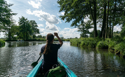 female kayaker enjoys paddling through the channel