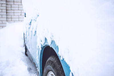 冬季汽车进入紧急状态。与天气有关的紧急情况。在冬天的暴风雪中，汽车被雪覆盖了。冰雪覆盖的汽车车轮在雪