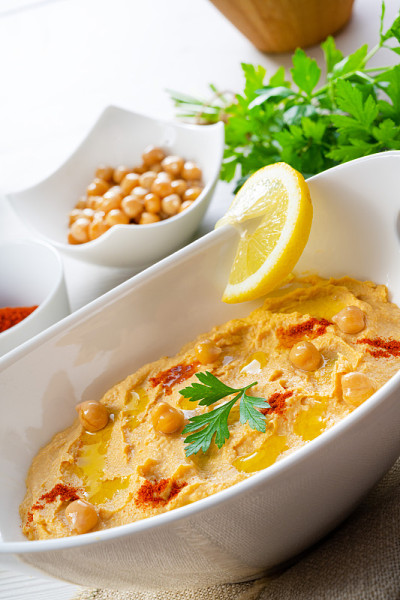 hummus paste with lemon and chilli on white backgr