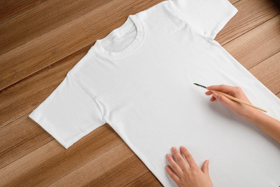 Painting on a white t-shirt with a brush, close up