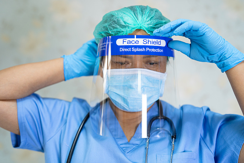 Asian doctor wearing face shield and PPE suit new 