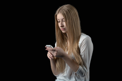 女孩看到手机上糟糕的短信后感到沮丧