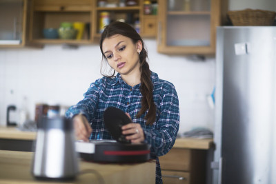 一个年轻的女人在厨房里清理一个松饼