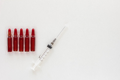 Top view of ampoules and syringe with vitamins gro