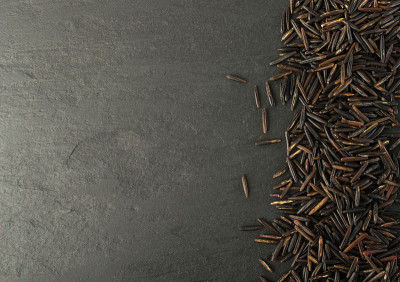 Raw Black Wild Rice on Dark Stone Background