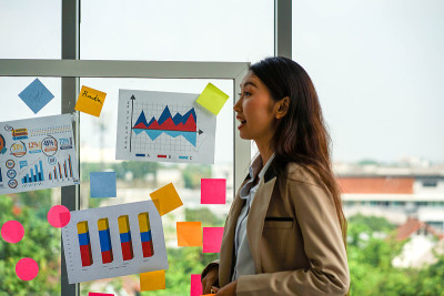 Mixed race business woman standing and presenting 