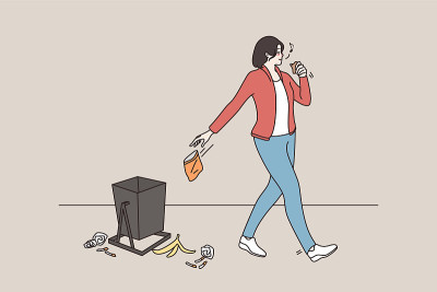 粗心大意的年轻女子在街上乱扔垃圾