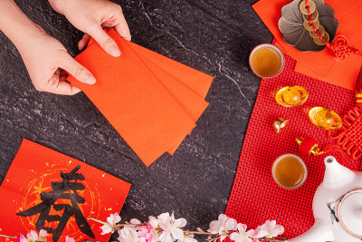 中国农历一月新年的设计理念——女人拿着，给红包(ang pow，红包)作为压岁钱，俯视图，平躺，头顶