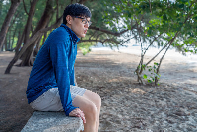 亚洲男人在夏天的早晨在海滩上做运动。