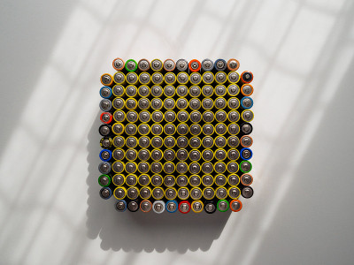 A large number of old AA batteries of different co