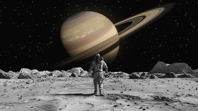 勇敢的宇航员穿着宇航服在月球上自信地走向土星，身上覆盖着岩石。第一位登上月球表面的宇航员。人类的重大