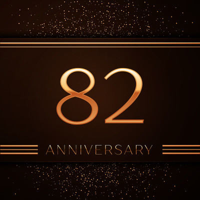 现实的82周年庆祝标志。金色的数字和金色的五彩纸屑在棕色的背景上。彩色矢量模板元素为您的生日派对