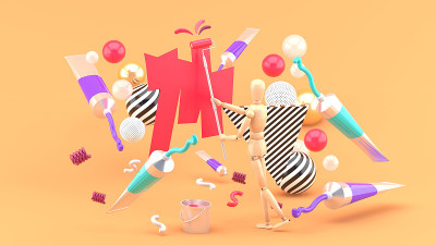 在橘色背景上的彩色管和彩色球之间的木偶绘画。3 d渲染。