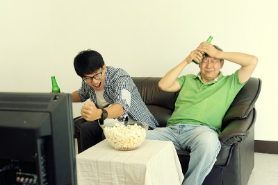 年轻人和老人父亲儿子看足球