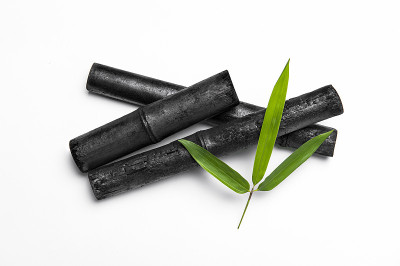 竹炭枝和绿叶孤立在白色背景下。