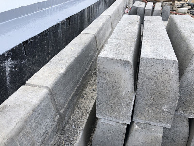 堆混凝土的路边石也。道路建设工程的建筑材料