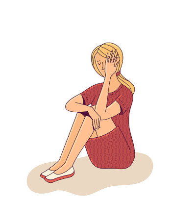 Crying young woman sitting alone