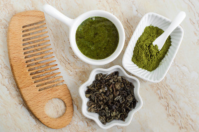 Diy绿茶抹茶面膜(刷洗)，小白碗，棉垫和木梳子。自制天然美容、面膜、spa配方。俯视图，复制空间。