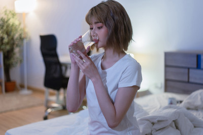 亚洲妇女晚上睡觉前喝水