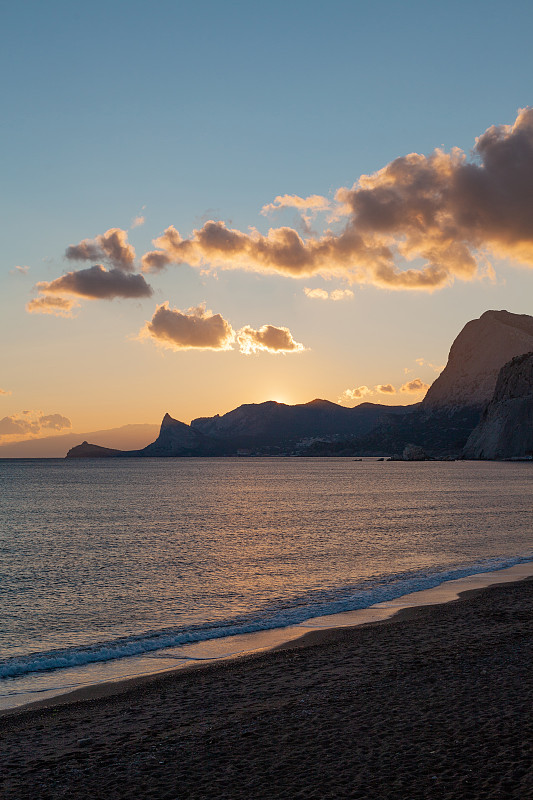 Mountains at sunset by the sea