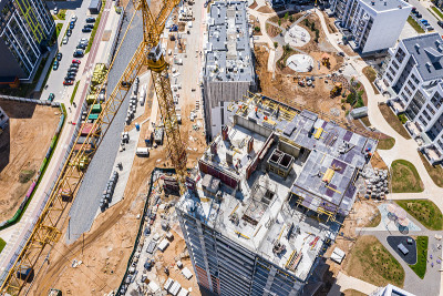 新建住宅区鸟瞰图。起重机正在施工中的高层住宅中工作