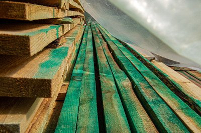 wooden beams for building a house are dried in nat