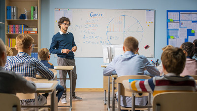 充满爱心的老师向一群聪明多样的孩子讲解课程。在小学用聪明的多民族学习科学，饶有兴趣的听老师讲课