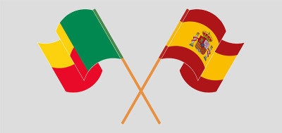 Crossed and waving flags of Benin and Spain