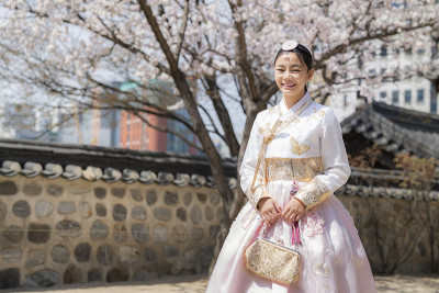 在汉城一座古老的京福宫，身着韩服的韩国女子微笑着