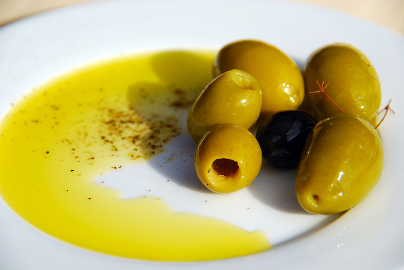 Plate with extra virgin olive oil and mediterranea