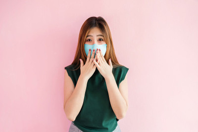 Covid-19或冠状病毒形势概念。恐慌的年轻女子戴着医用口罩。